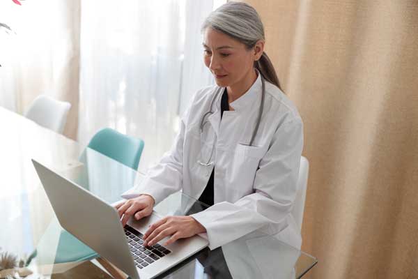 medical specialist working on laptop